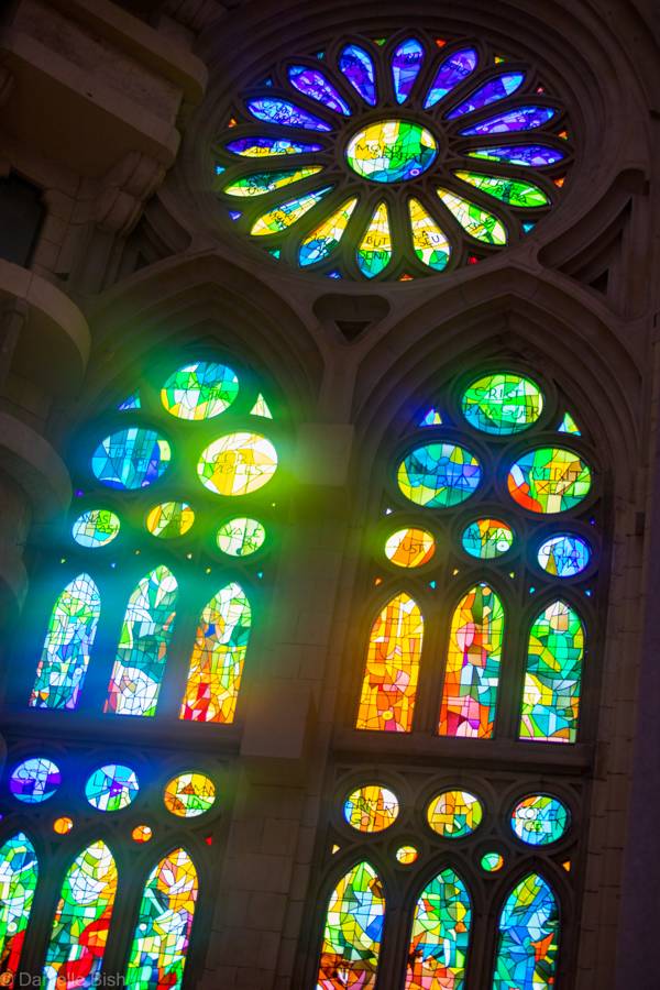 Stained glass rose window glowing inside the Sagrada Familia